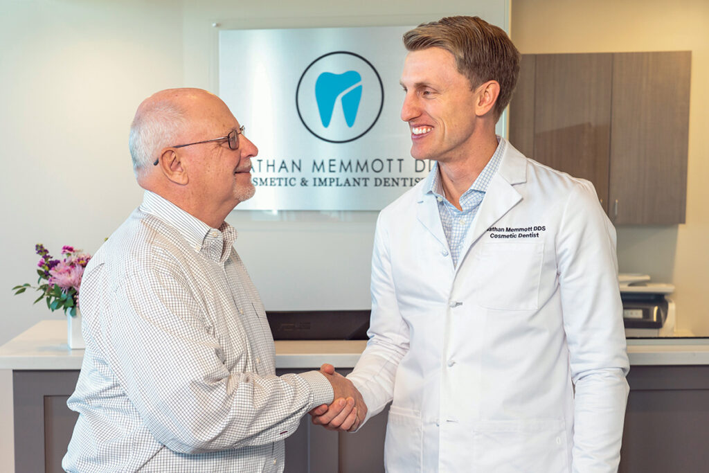 Dr. Memmott shaking hands with a patient.