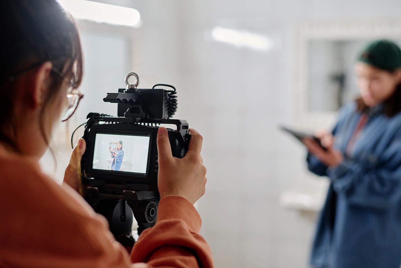 A woman filming a client with a pro camera