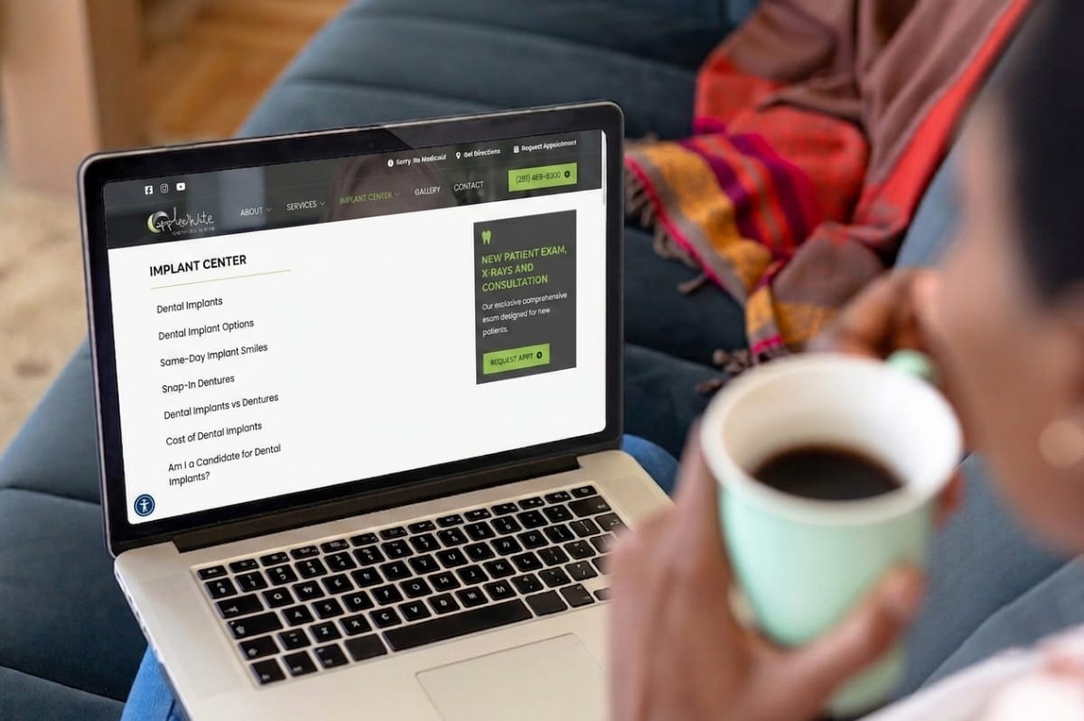 A woman examining a dental website on her laptop